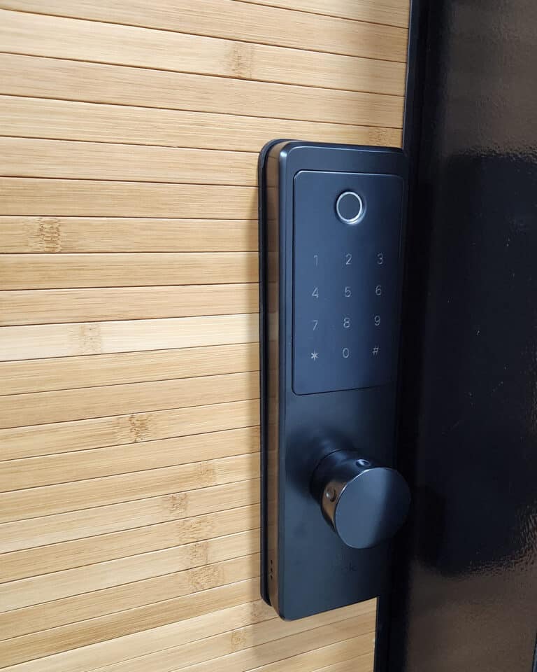 Elock Wize finish black installed by smart lock israel. A door designed with wood cladding